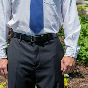 Model wearing Classified Black Leather Belt with blue dress shirt and gray dress pants. Lawyer belt