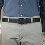 The Specialist Belt; man wearing a black genuine leather belt with a carbon fiber buckle